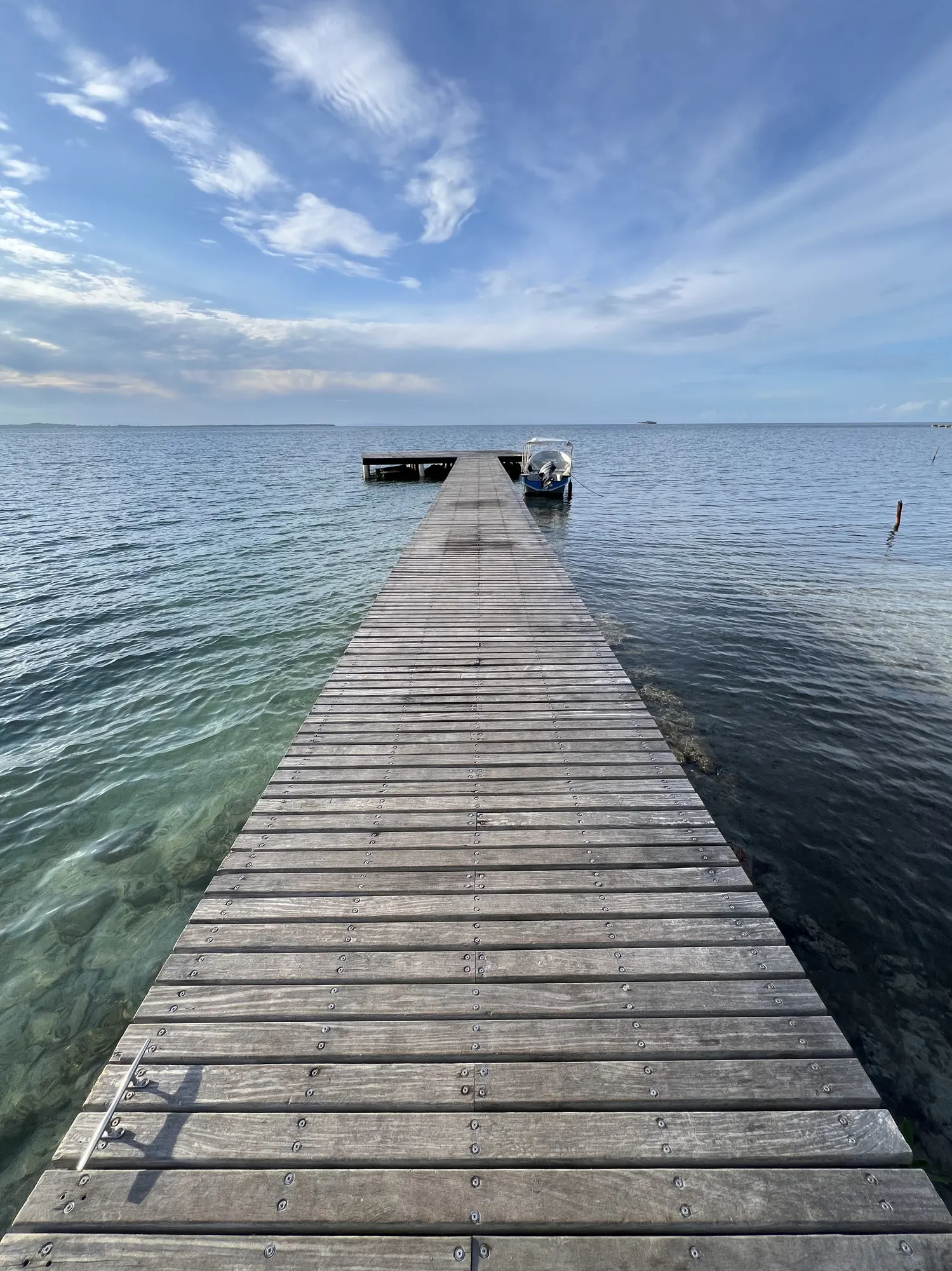 The pier at midday, clear water on both sides