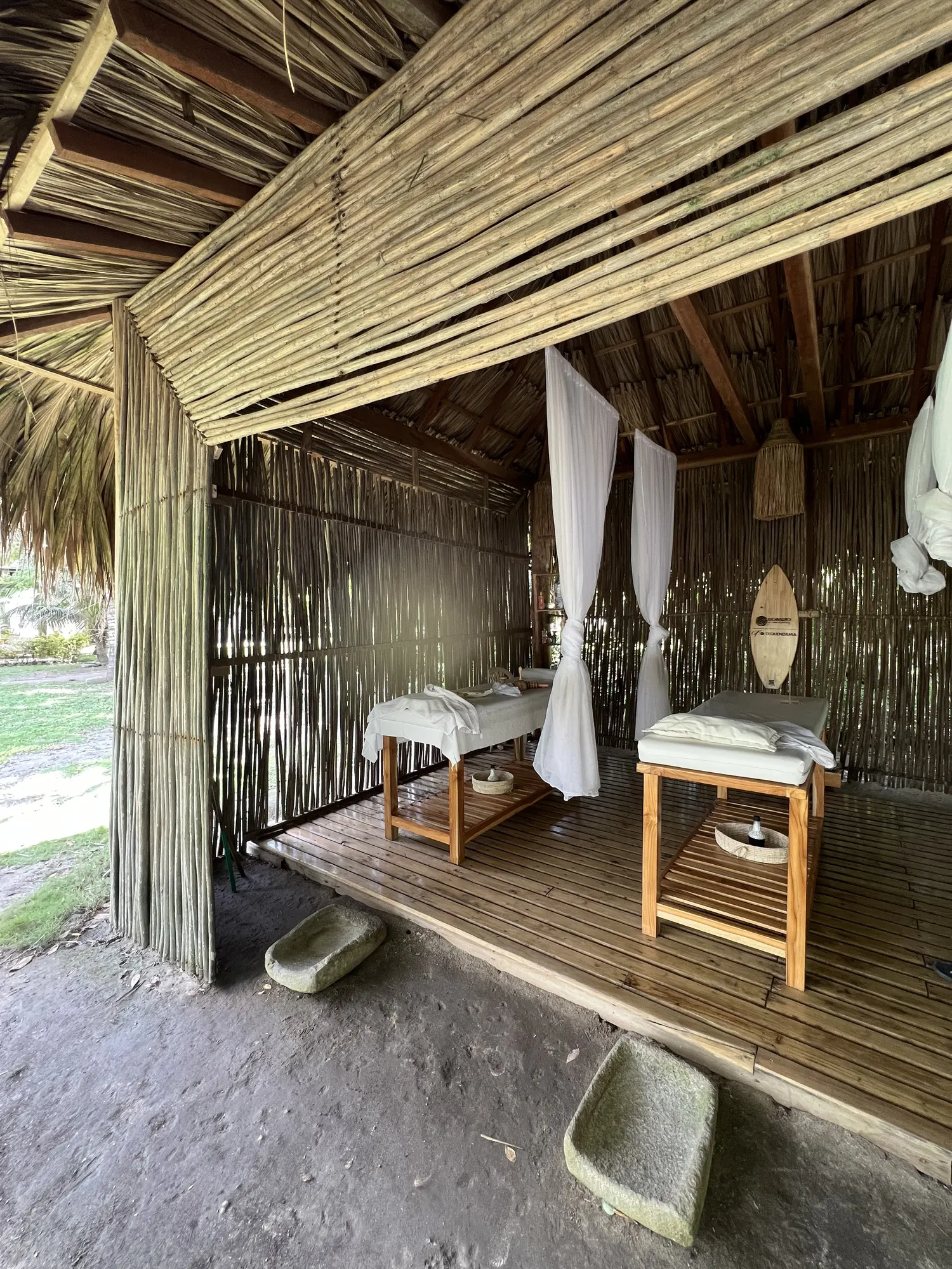 Open-air spa cabin with two massage tables