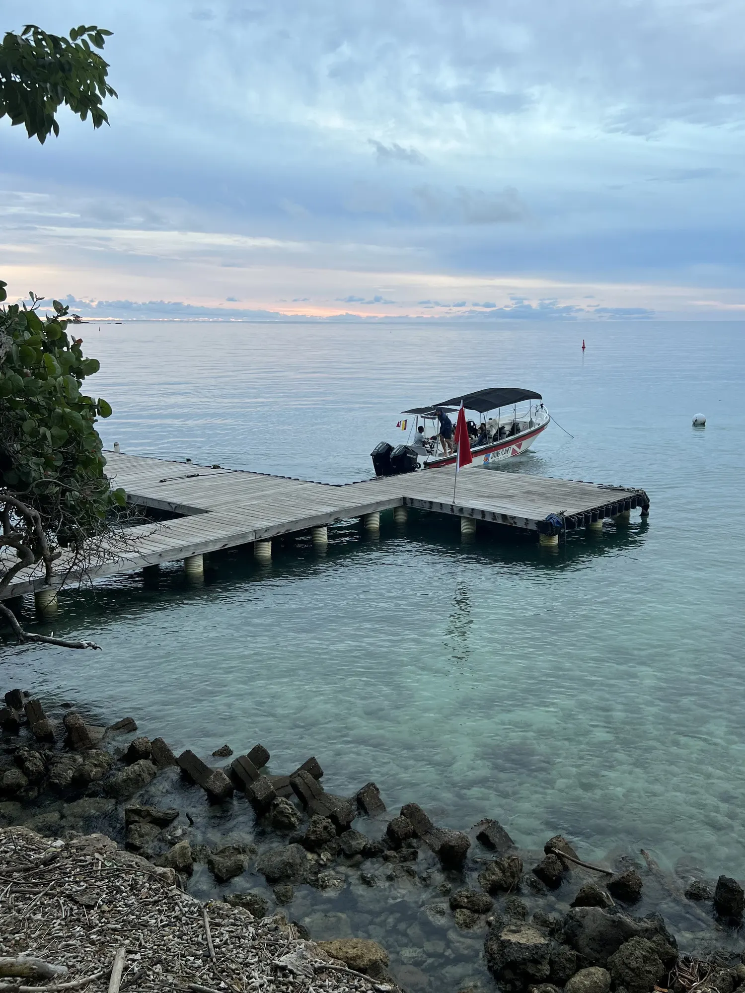 The hotel jetty and the transfer boat in soft evening light