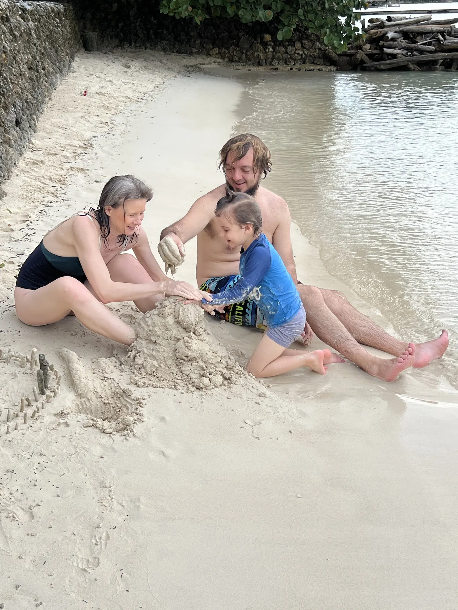 A family building in the sand