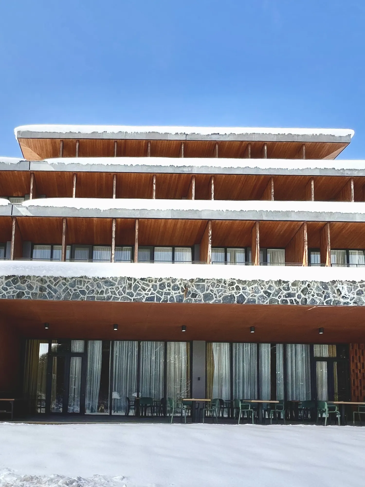 The building: wood, stone and fresh snow