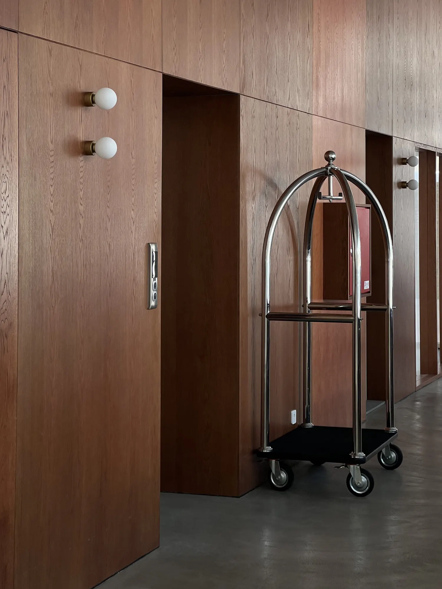 Wood-panelled hall and a brass luggage cart