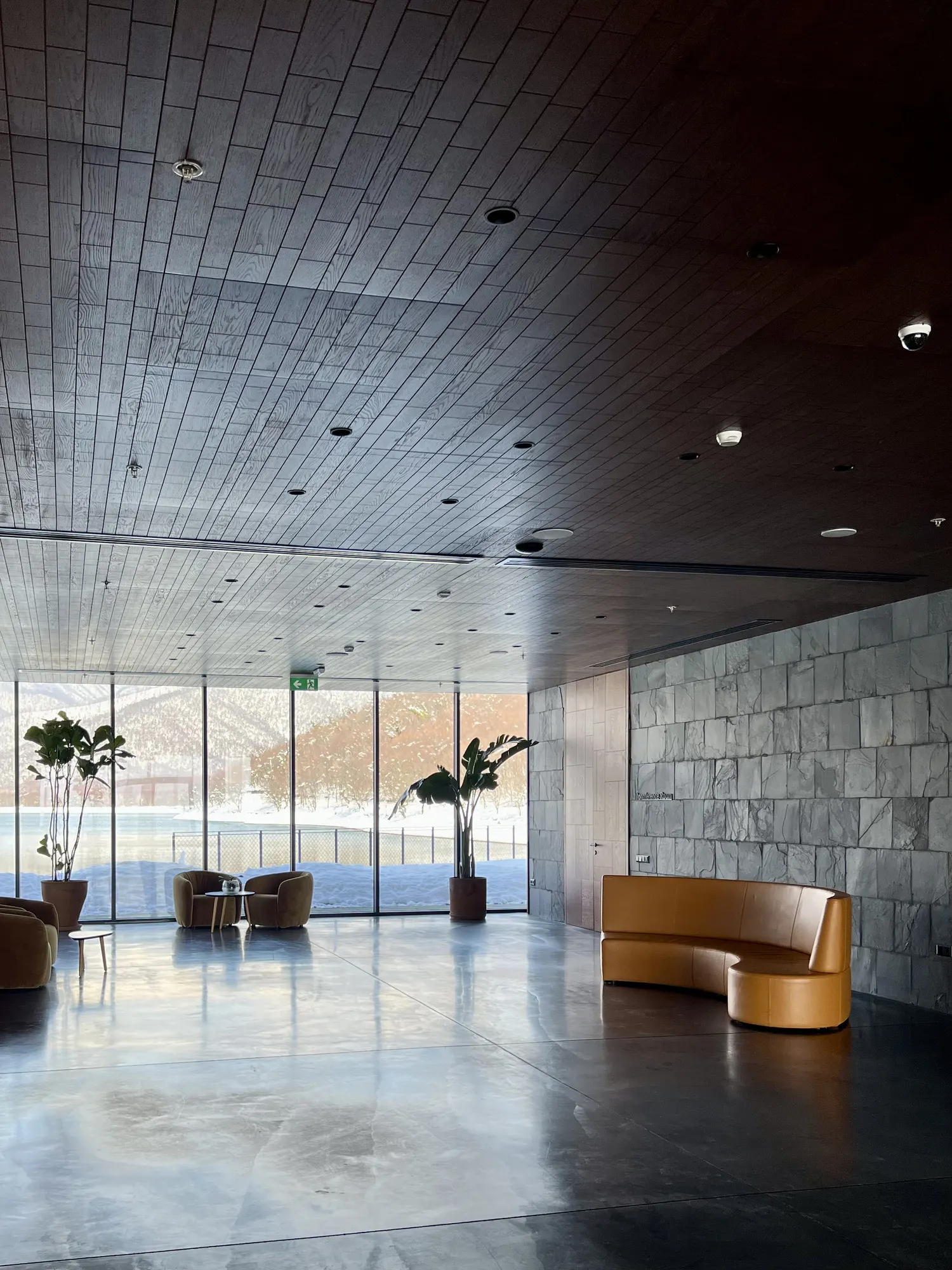 Lobby with a stone wall and a curved sofa