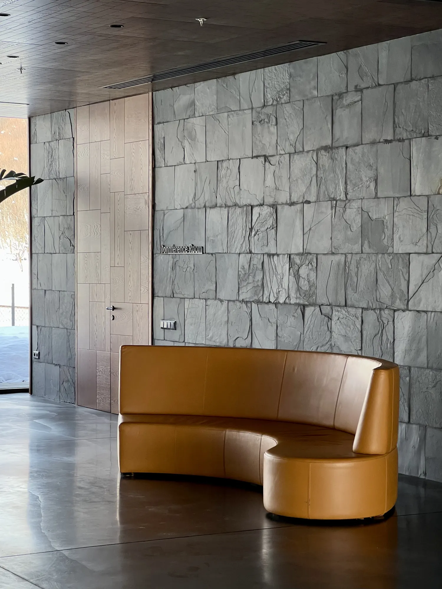 Leather sofa against grey stone