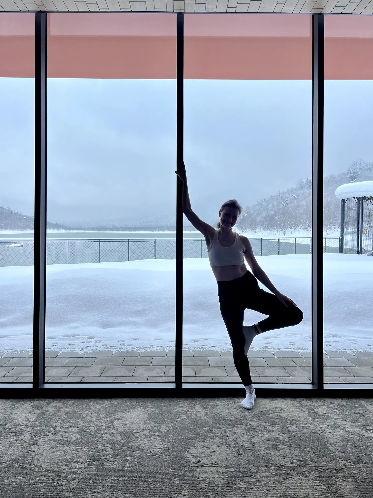 A yoga pose at the glass wall