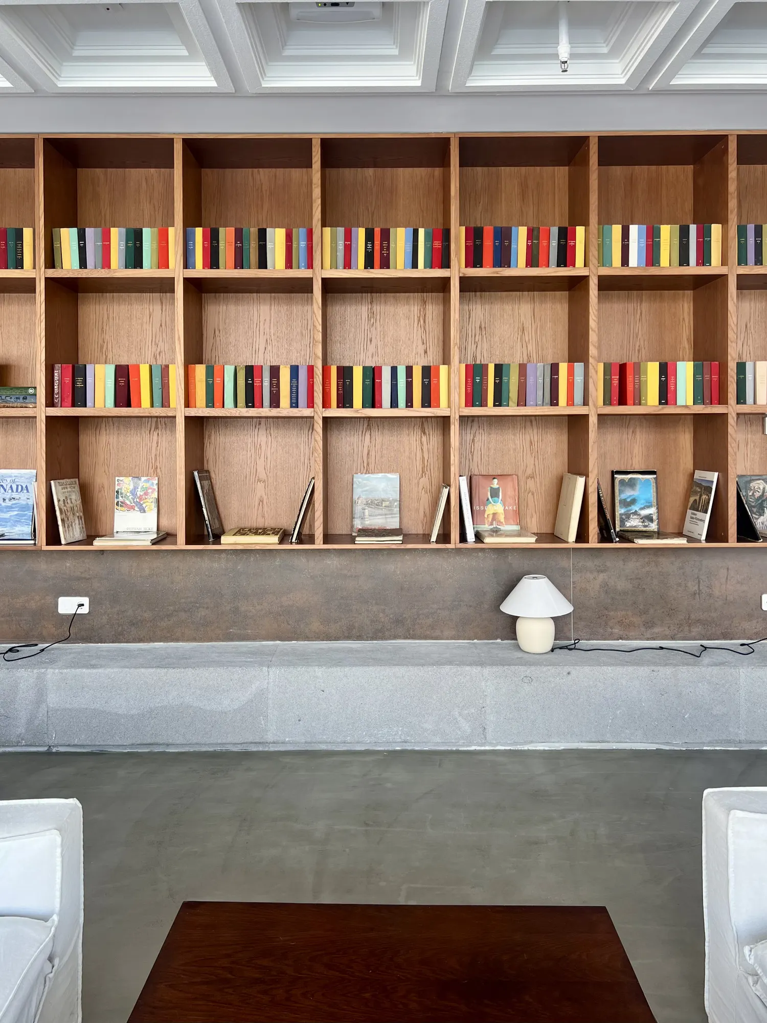 Shelves of books and a small lamp