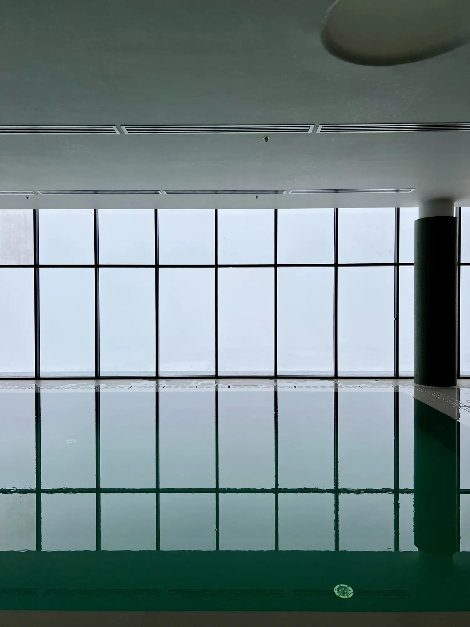 Still water and a white sky