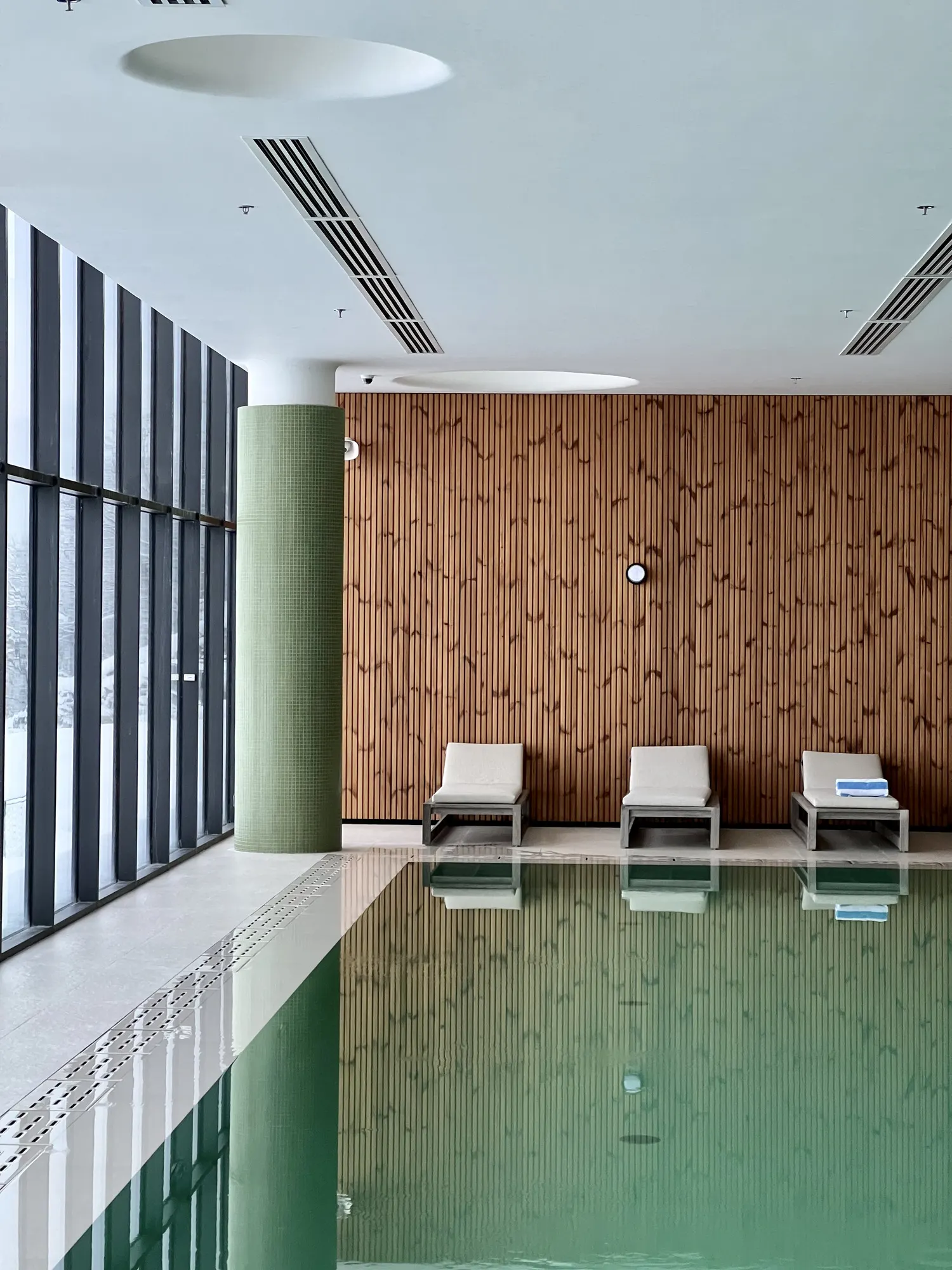 Three loungers against the wood wall